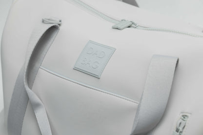 Light gray neoprene bag with a visible dad bag brand label on a light gray background