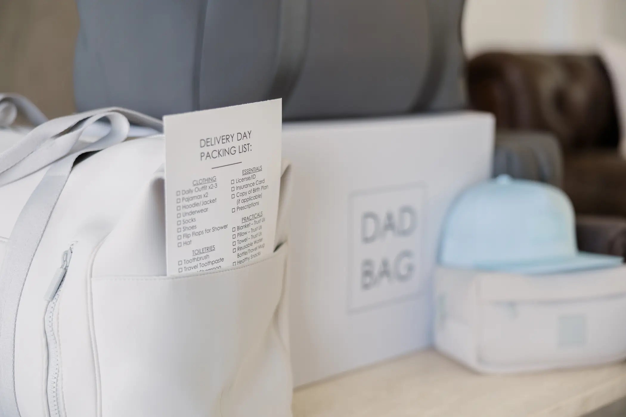 Packing list for delivery day with a Dad Bag and accessories on a table